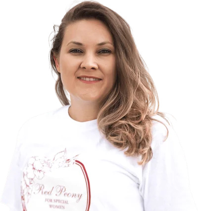 Olga, founder of Red Peony, smiling in a white Red Peony T-shirt