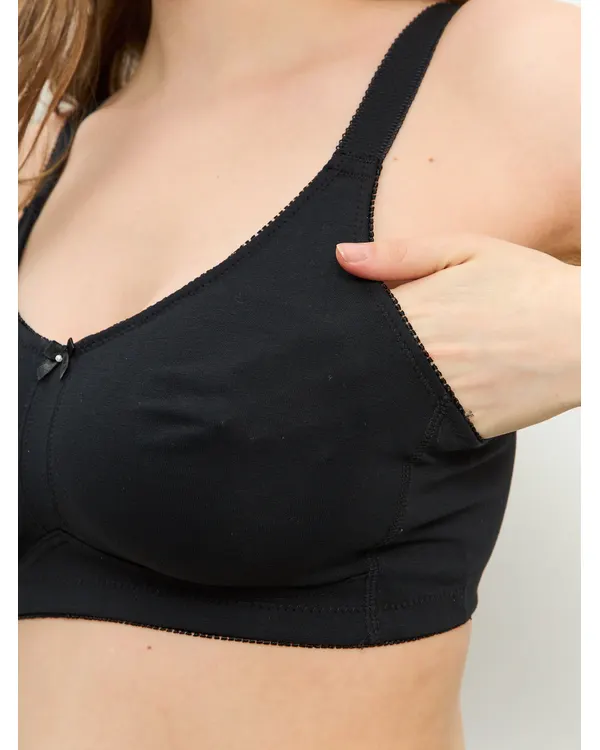 Hand opening the pocket inside the black everyday mastectomy bra