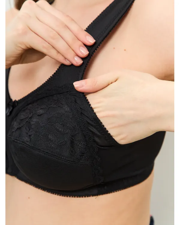 Hand opening the pocket inside the black lace mastectomy bra